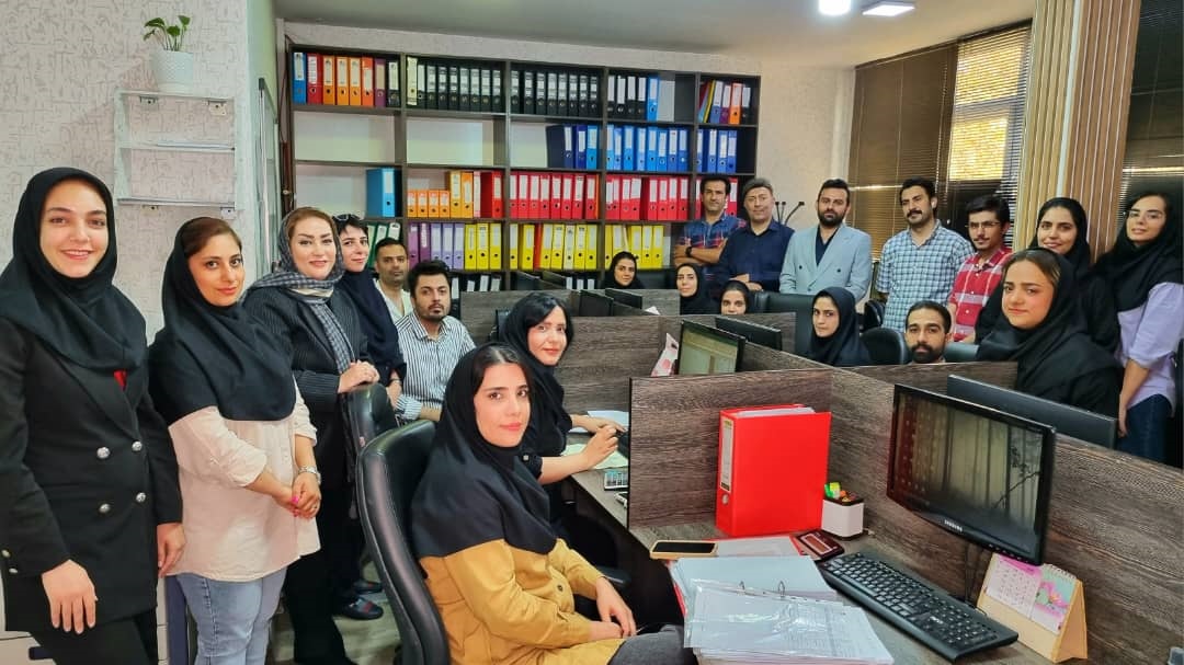 A group of people in an officeDescription automatically generated