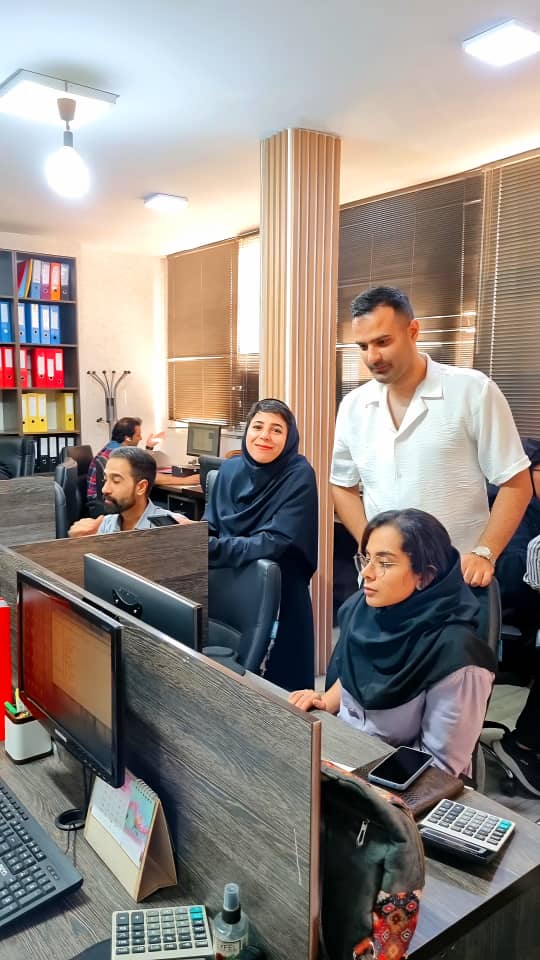 A group of people in a roomDescription automatically generated