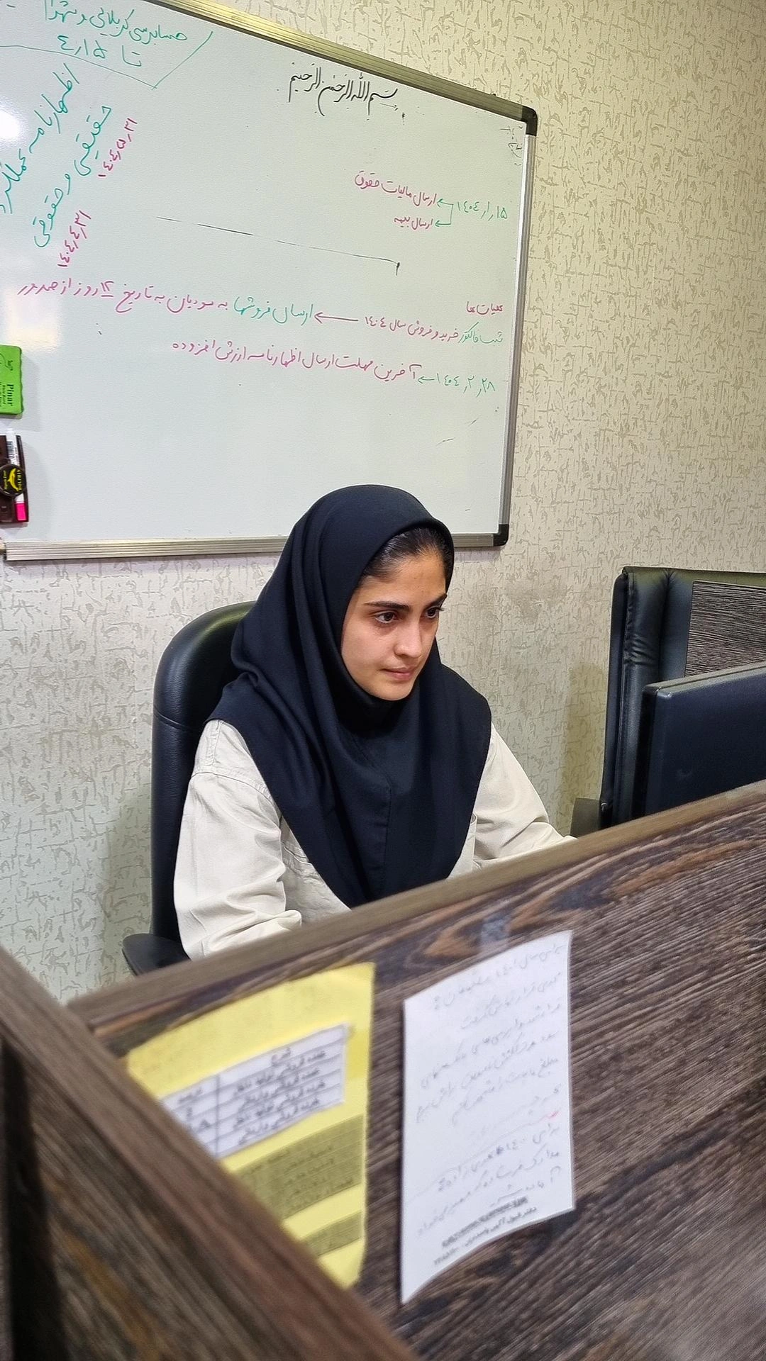 A person sitting at a deskDescription automatically generated